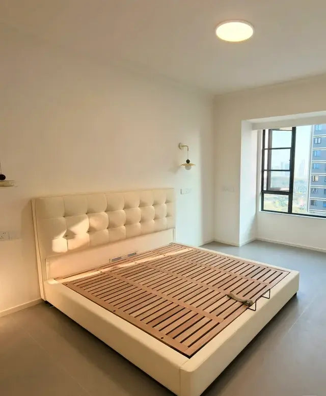 Upholstered bed frame with visible slat support before the mattress is placed