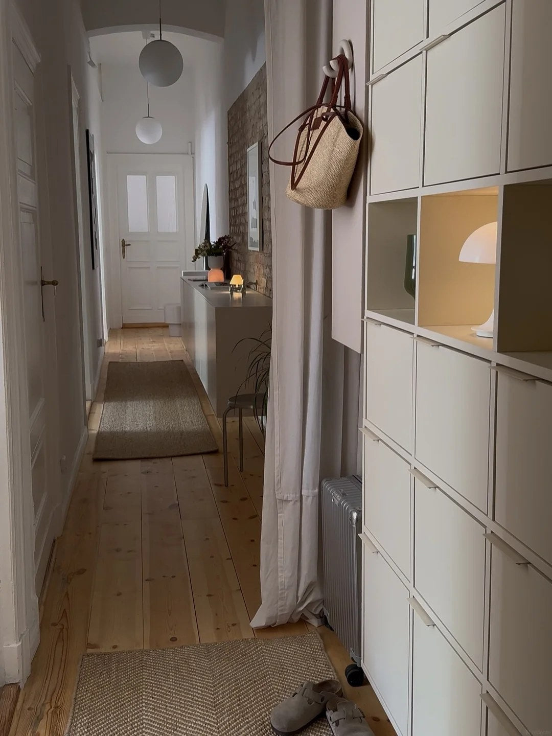 Use a full-height wardrobe wall to quiet the hallway
