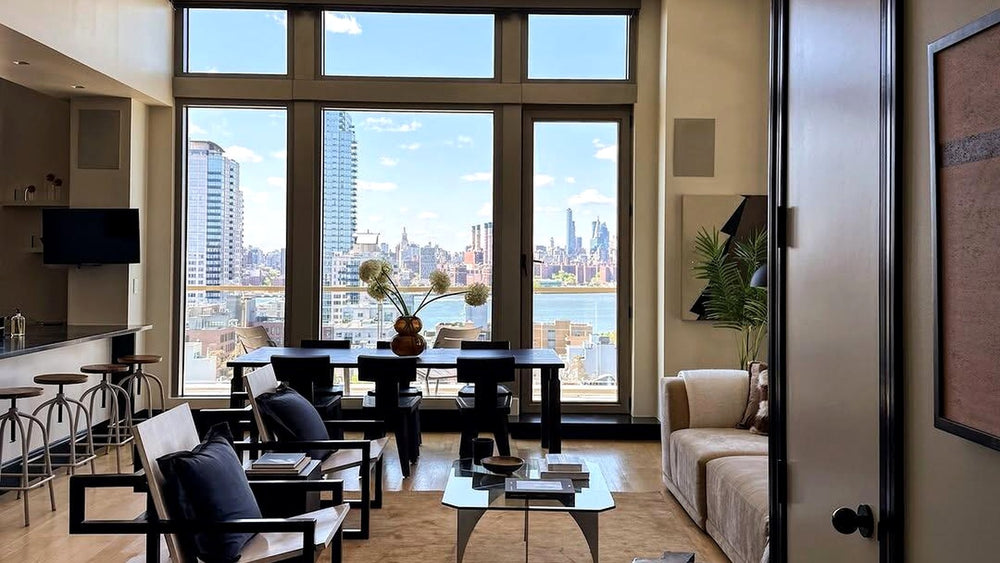 Warm modern New York loft living room with city view