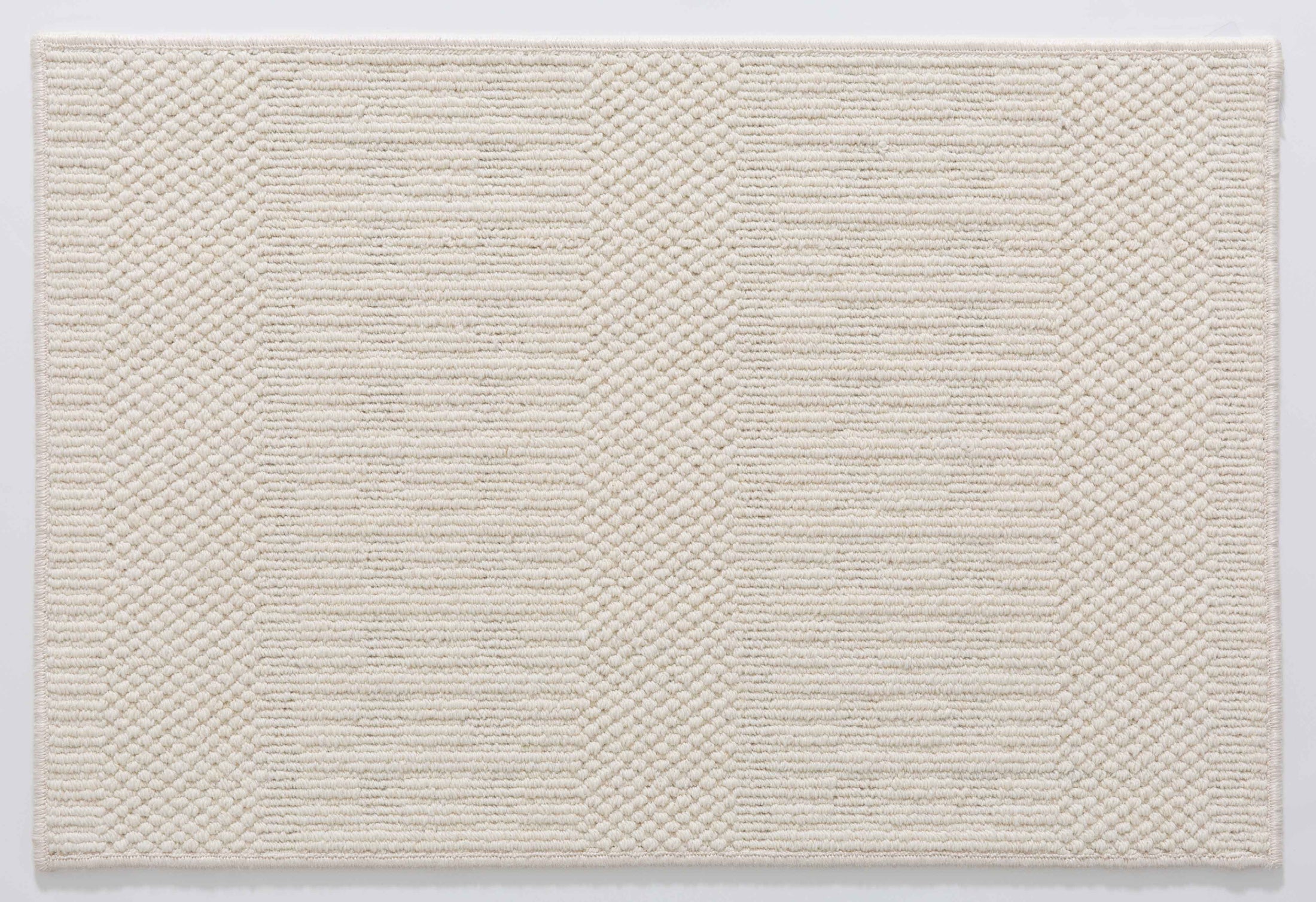 Wheat Arc Area Rug in a finished interior.