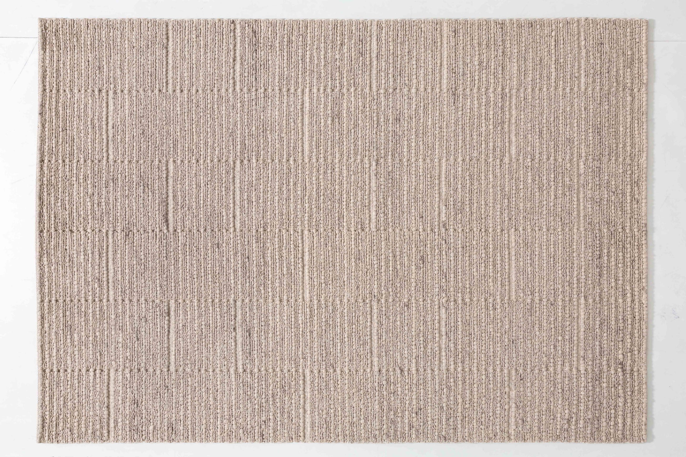 Pebble Atlas Area Rug in a finished interior.