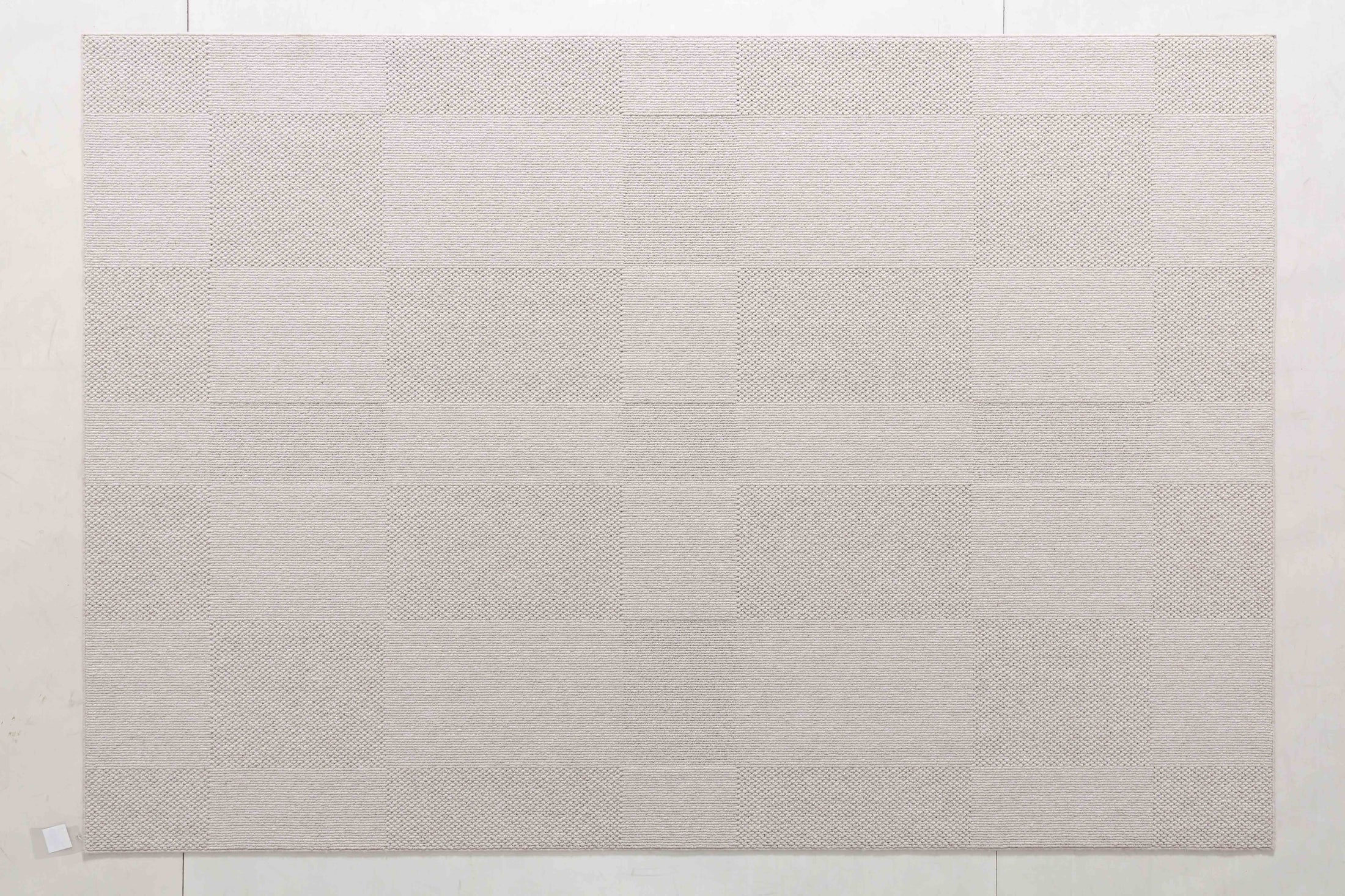 Wheat Cairn Area Rug in a finished interior.