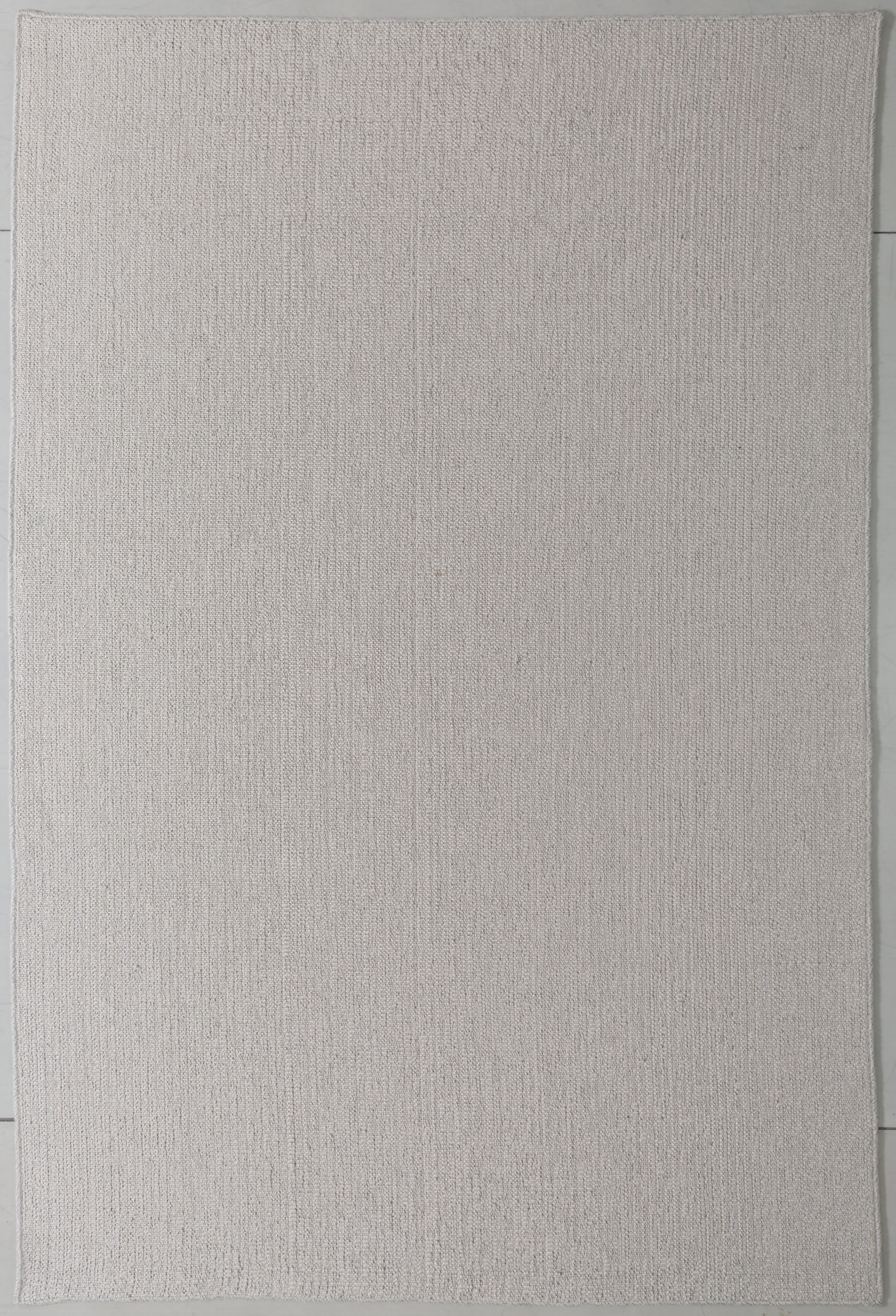 Luster Cairn Area Rug in a finished interior.