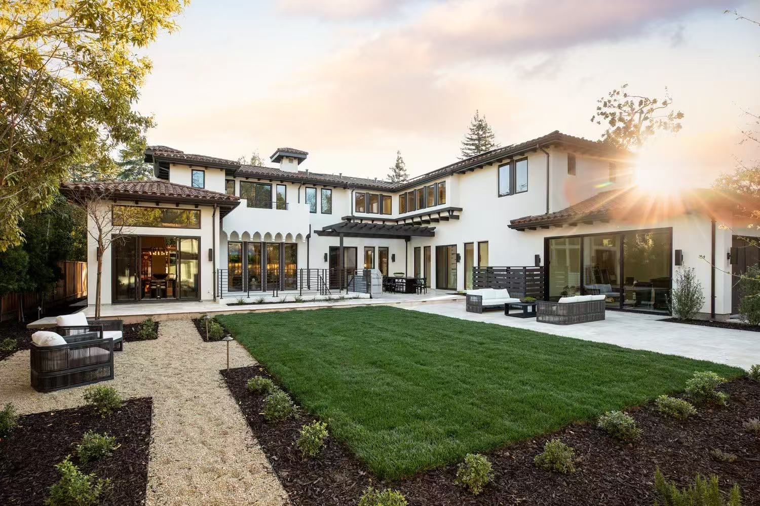 Rear garden view of the San Jose residence at sunset