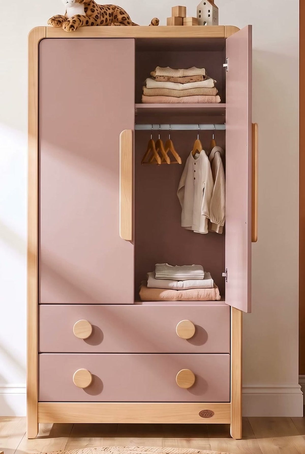  Open wardrobe showing a hanging rail, upper shelf and lower storage