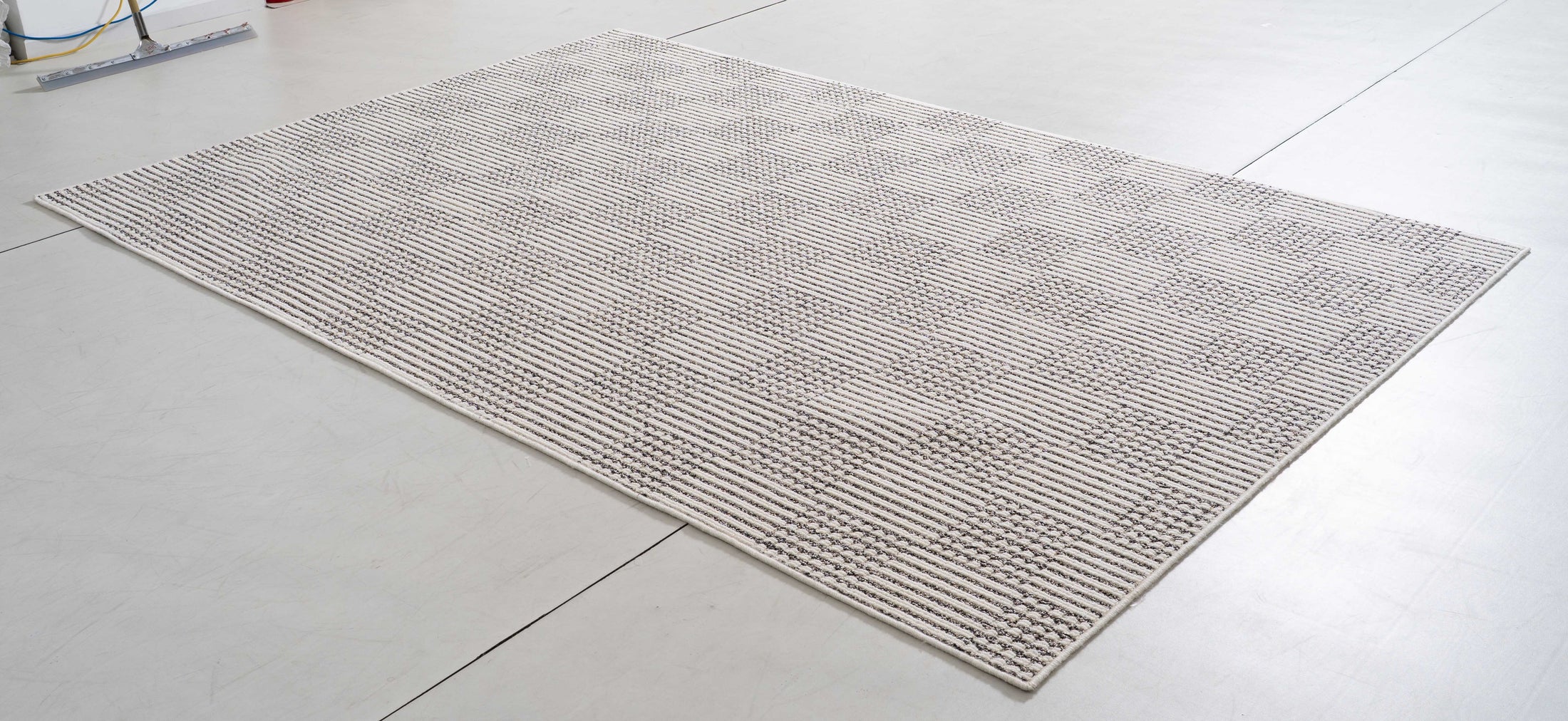 Midsummer Dune Area Rug in a finished interior.