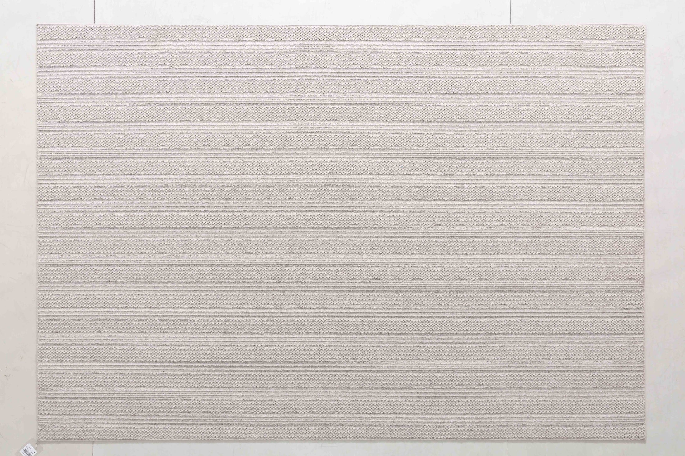 Wheat Atlas Area Rug in a finished interior.