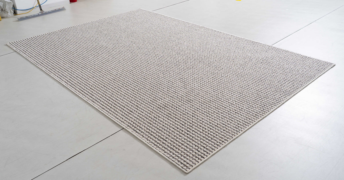 Midsummer Cove Area Rug in a finished interior.