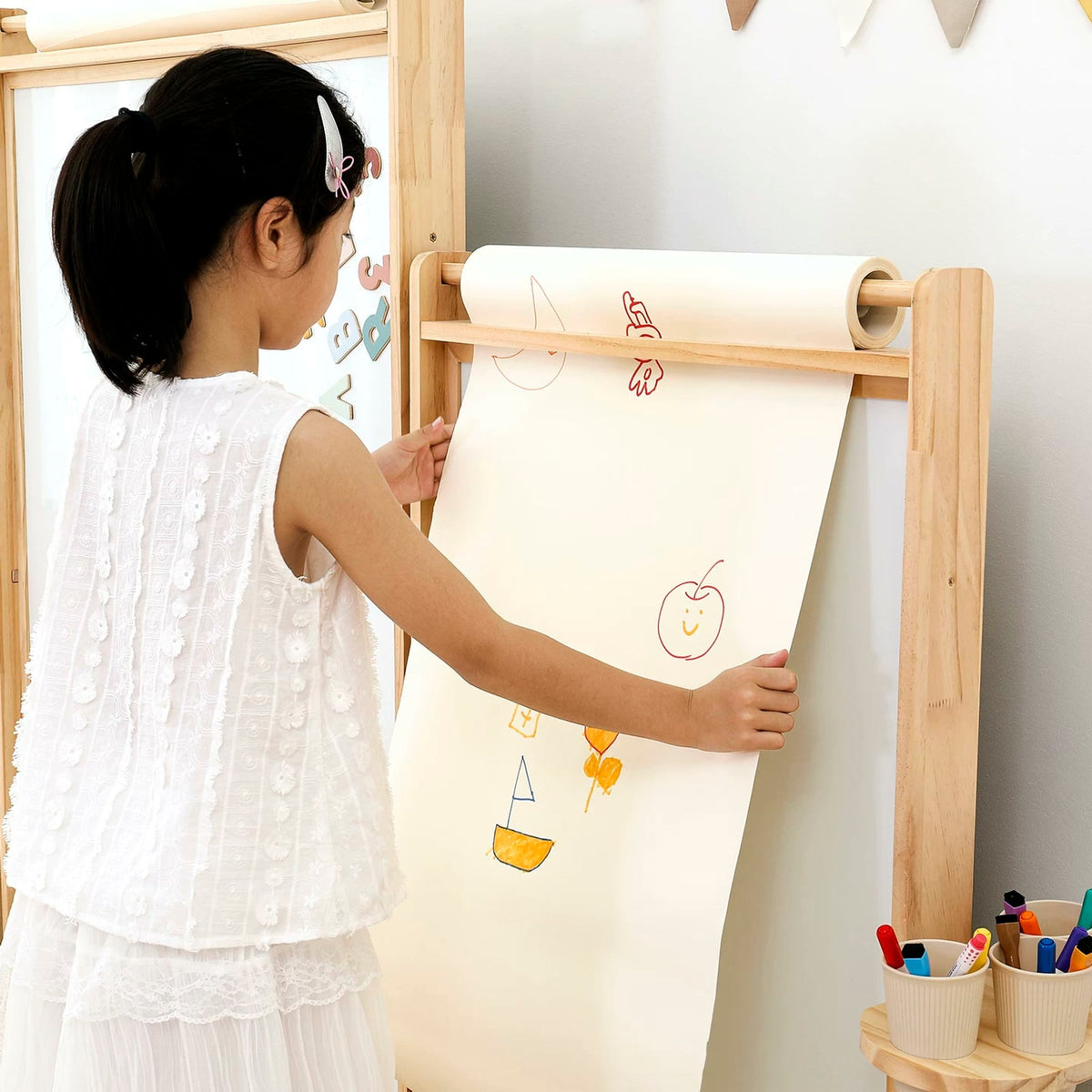  Paper unrolling over the upper wooden rod of the easel; paper shown for demonstration