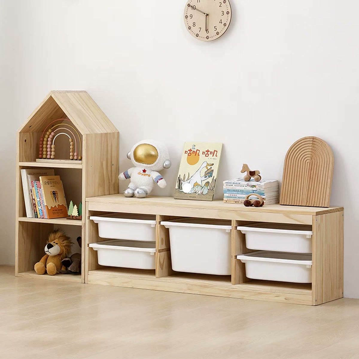 House-shaped bookcase beside a low pine cabinet with removable bins