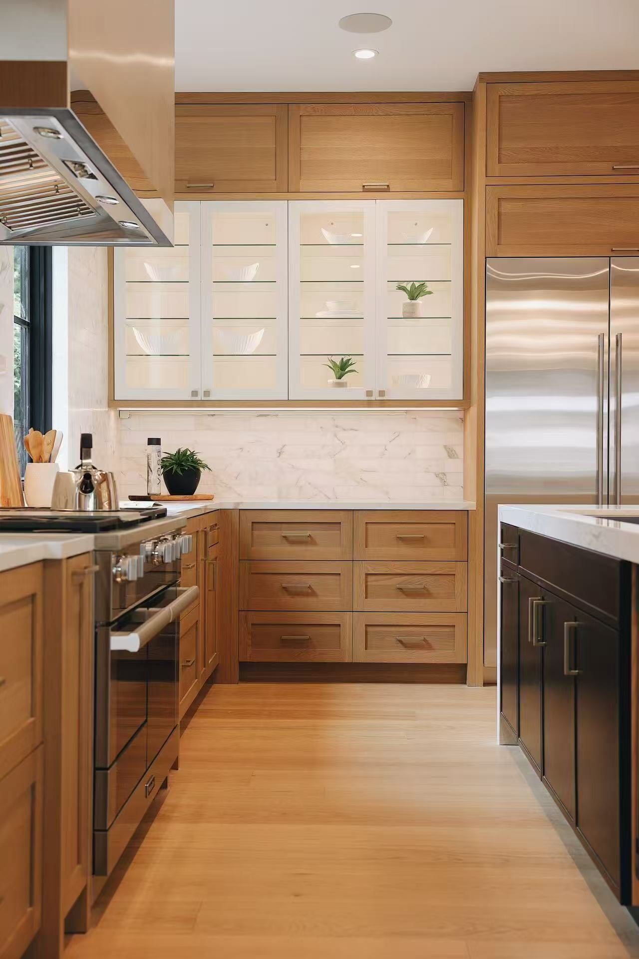 Galley kitchen view with timber cabinetry, range, and marble-effect backsplash