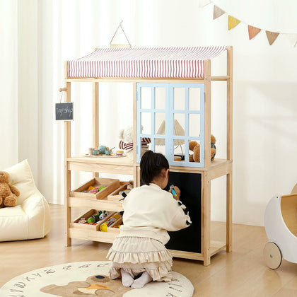  Child reaching into the wooden bins beneath the play shop counter