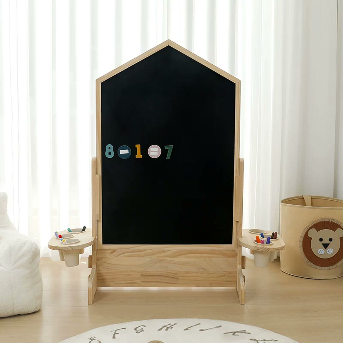 House-shaped chalkboard on a stationary rocket-shaped pine base