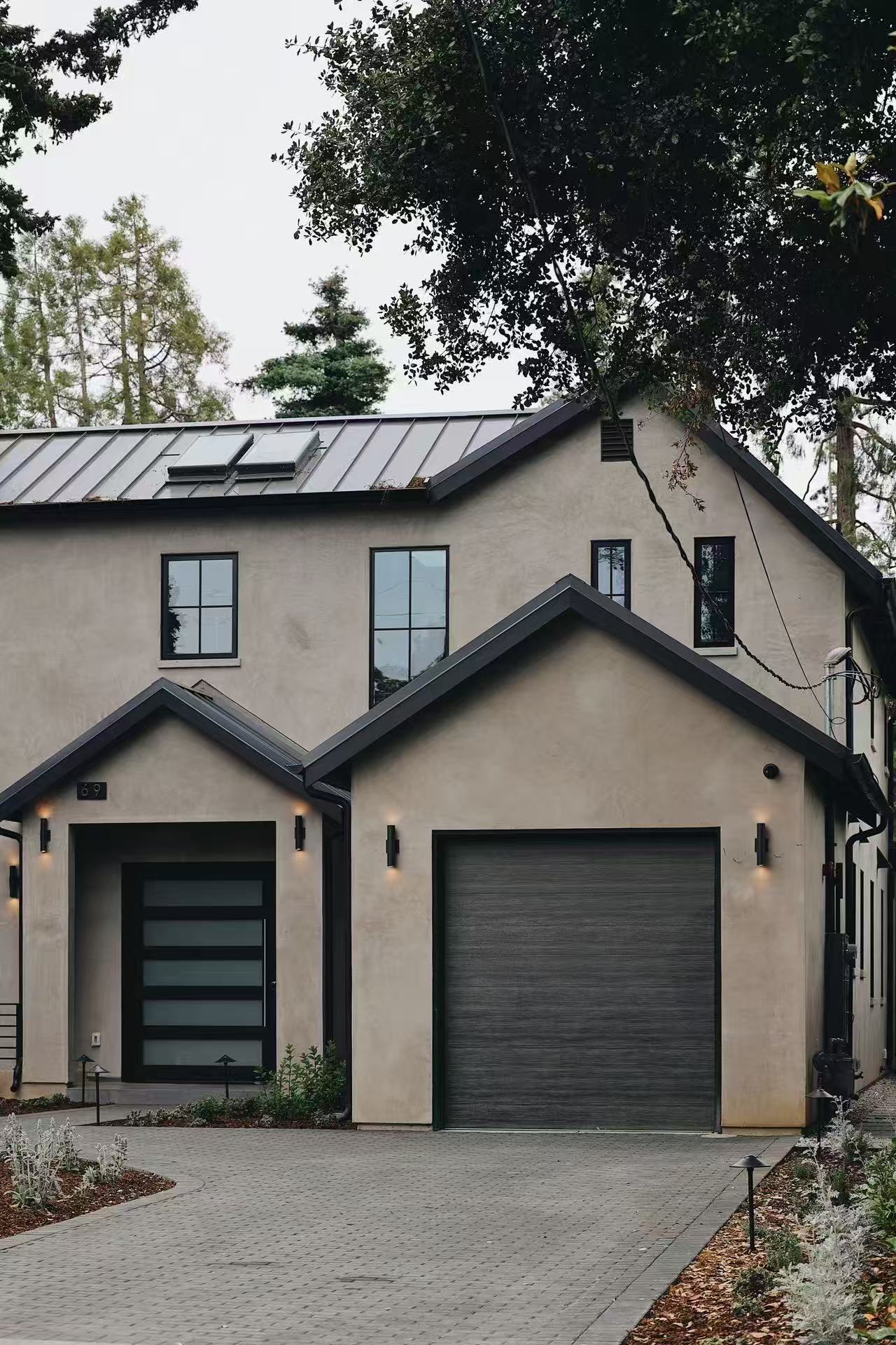 Side view of the residence showing roofline and garage massing