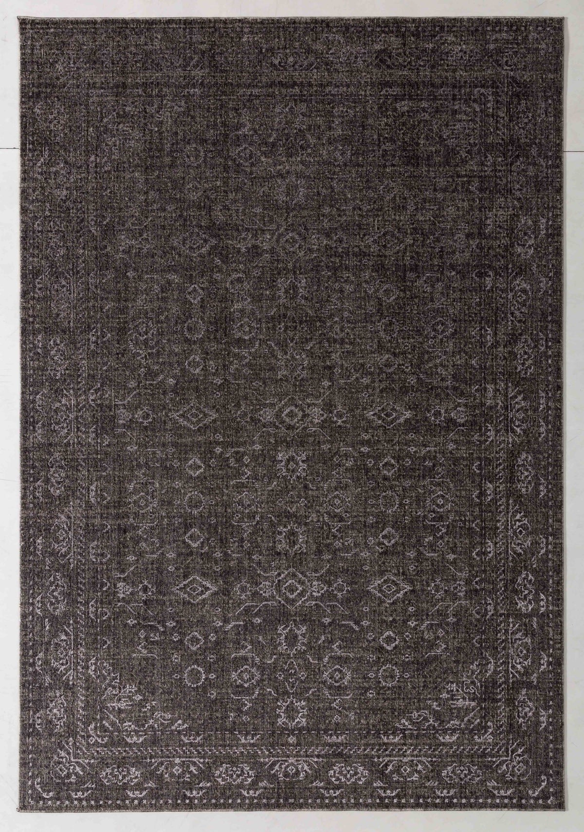 Painter Cairn Area Rug in a finished interior.