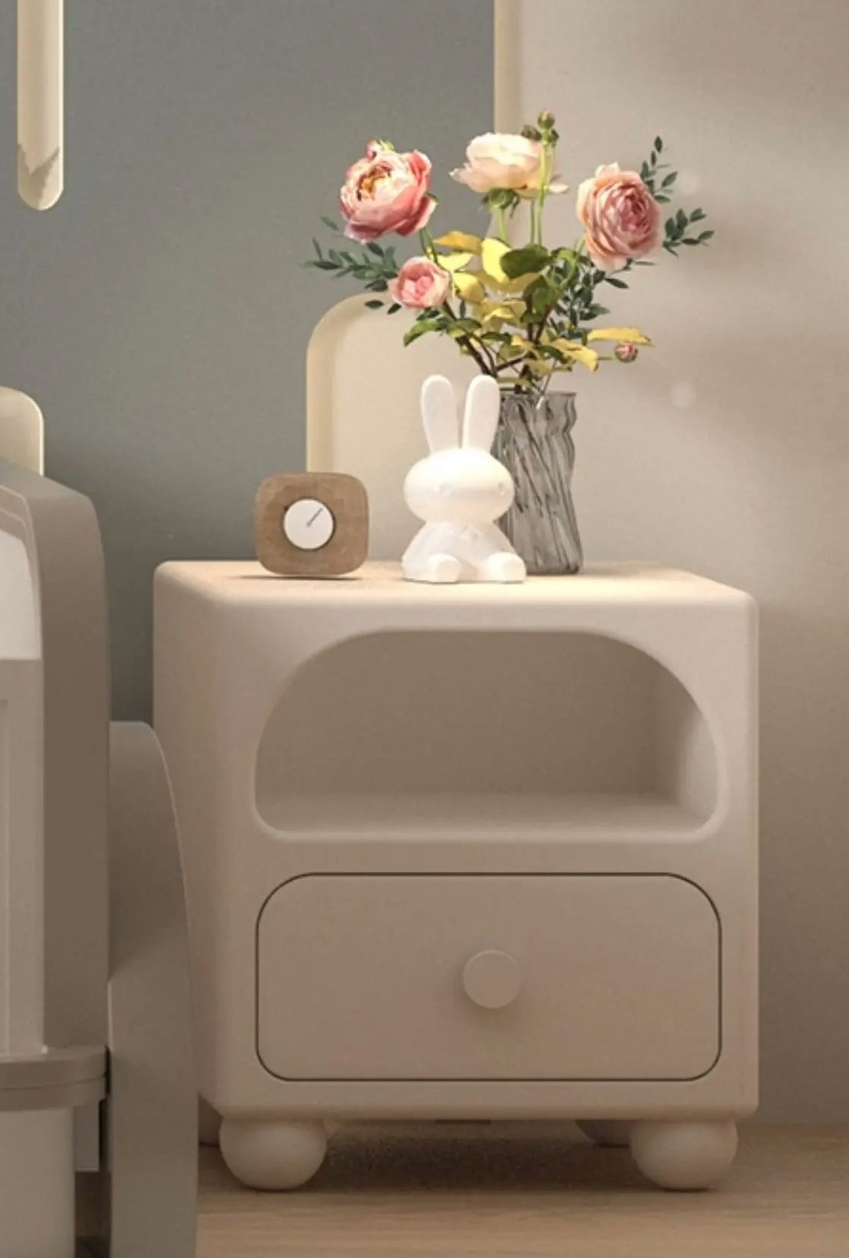  Cream nightstand with an open upper shelf, single drawer and rounded feet