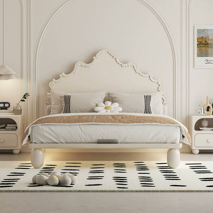  Cream French-style carved bed with rounded legs and illuminated space beneath the frame.