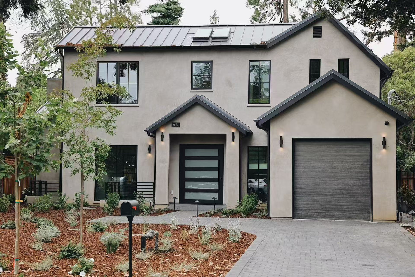Wide front view of the completed residence and driveway