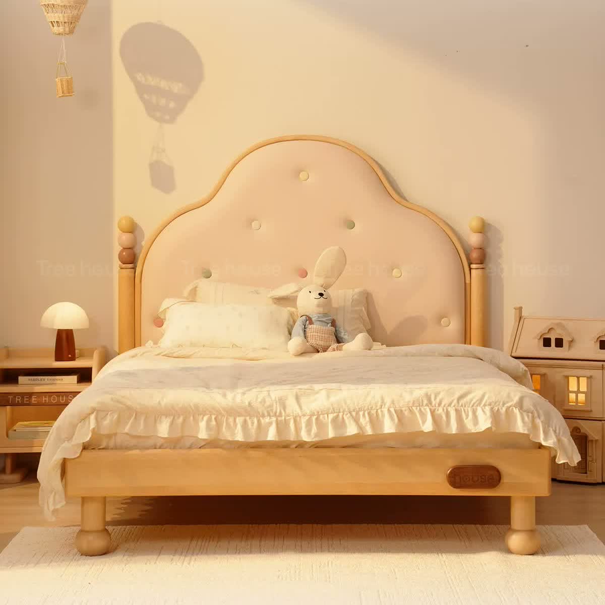 Candy button upholstered birch bed with scalloped headboard and rounded feet