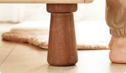  Close-up of a tapered wooden cabinet foot and its rounded base.