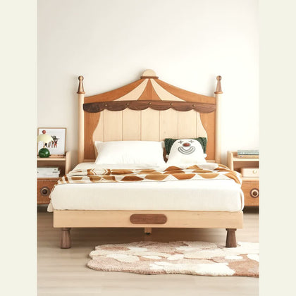 Front view of the circus-inspired wood bed with carved headboard
