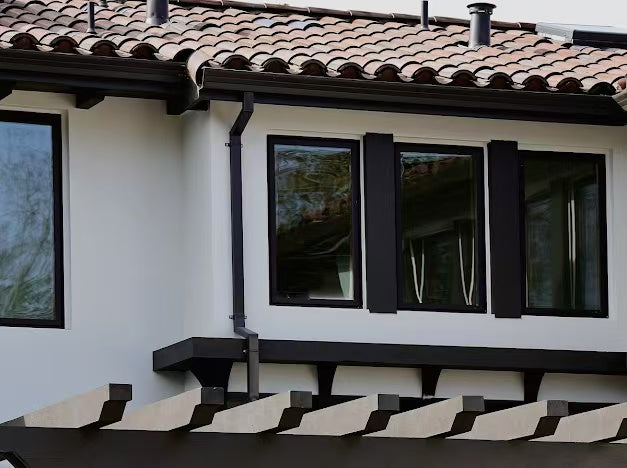 Exterior windows with dark shutters and tiled roof detail