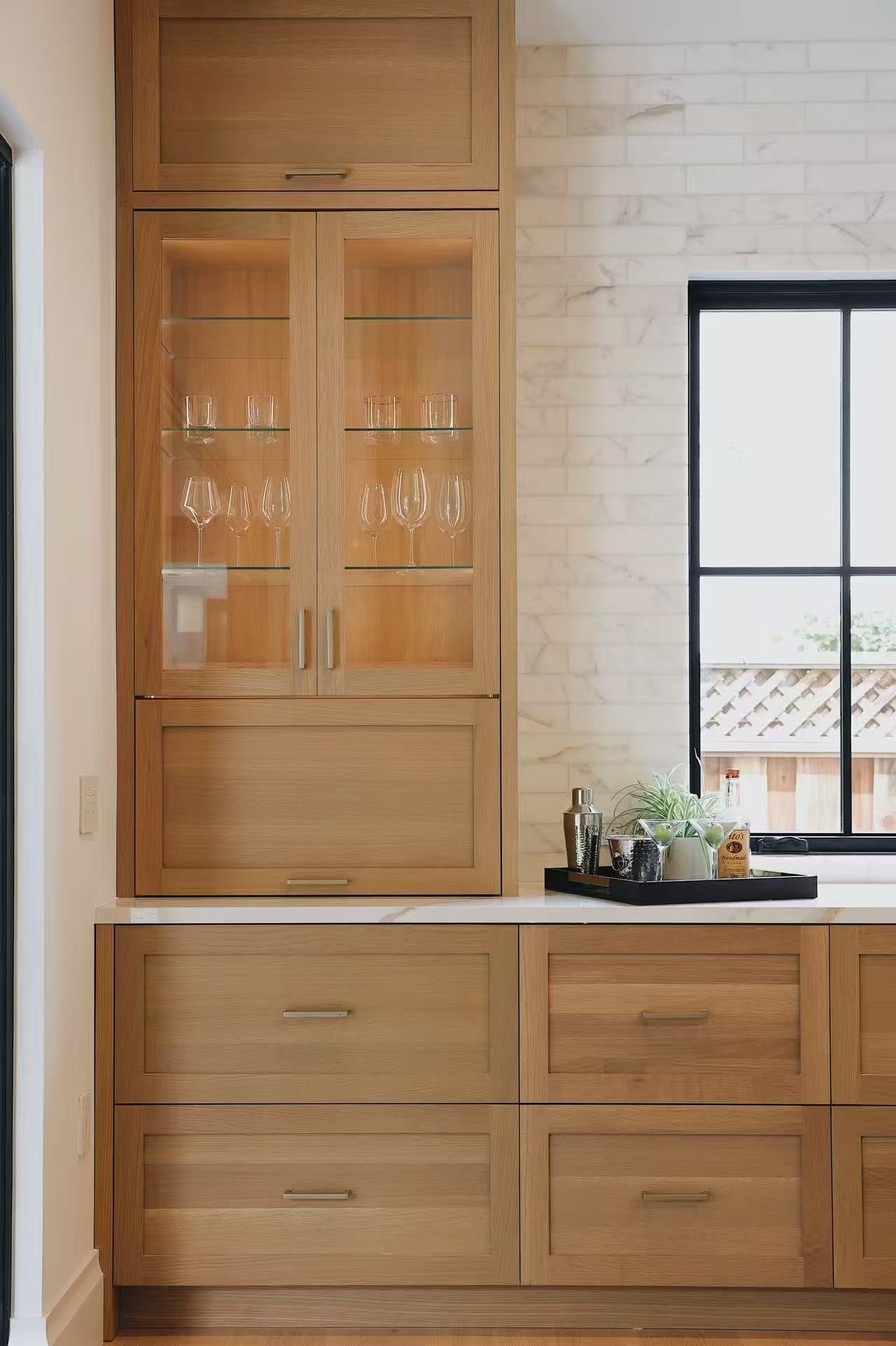 Timber cabinet detail beside black-framed kitchen window