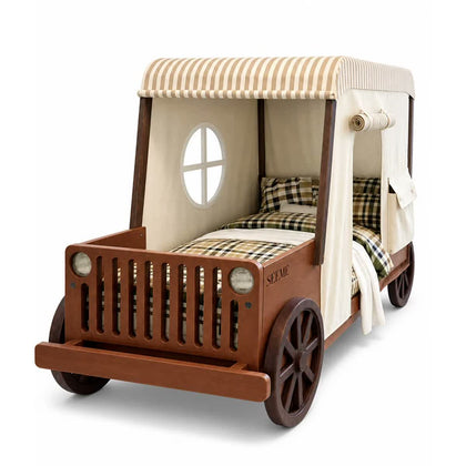  Dark wood car bed with fabric tent and decorative wheels.