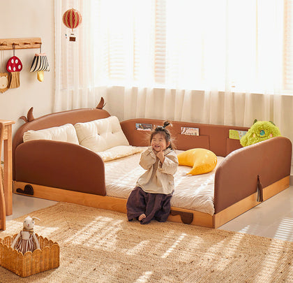  Brown upholstered cow bed with open side entry.