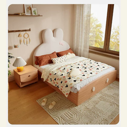 Wood storage bed with cream bunny headboard and pink bow in a styled bedroom.