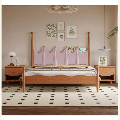  Pink scalloped upholstered bed with tall wood posts and curved footboard.