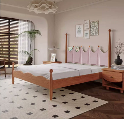  Three-quarter bedroom view of the pink headboard and wood bed frame.