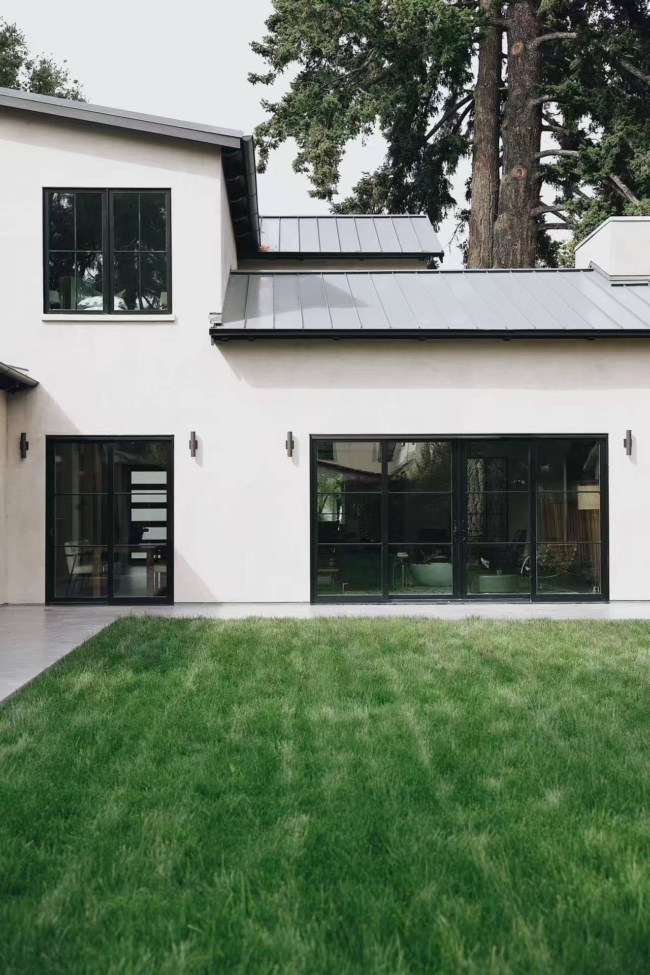 Rear garden view with lawn and upper-level window