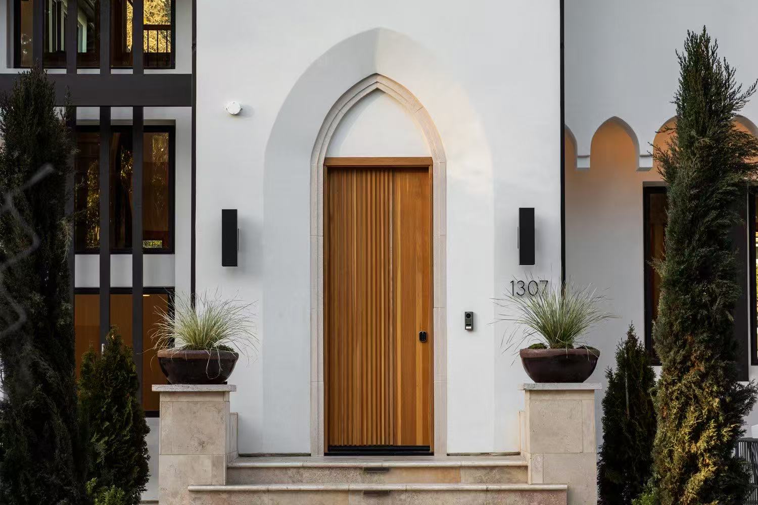 Close exterior view of the arched timber front door