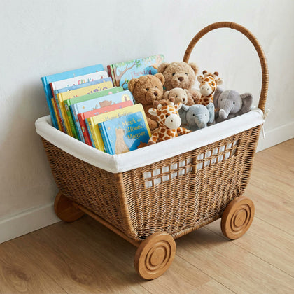  Fabric-lined version of the rattan trolley holding books and soft toys.