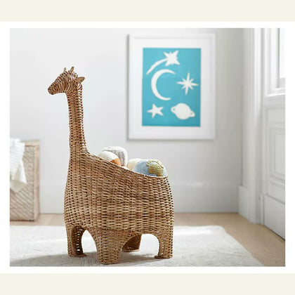  Natural-toned giraffe basket holding small soft toys beside a window.