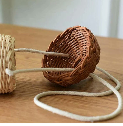  Pinecone mini bag with the cap lifted to reveal the opening and cord.