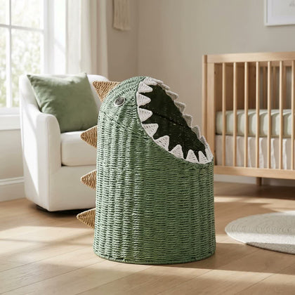  Green woven dinosaur basket with white teeth in a bright room.