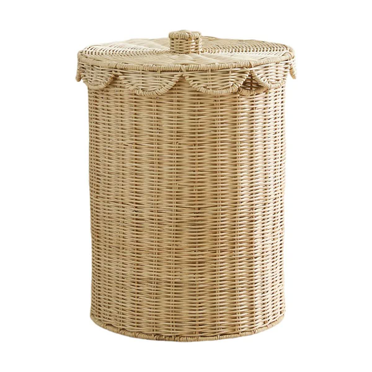 Natural rattan laundry hamper with a scalloped lift-off lid.