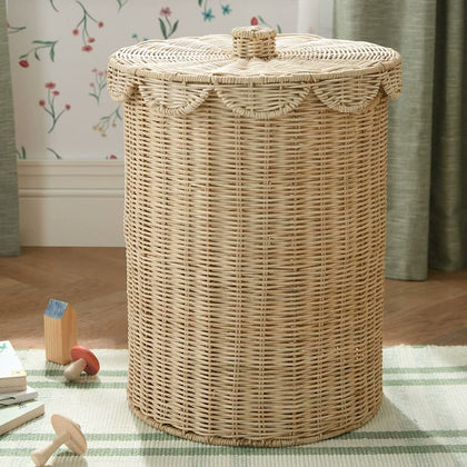  Round woven laundry hamper standing on a striped rug.