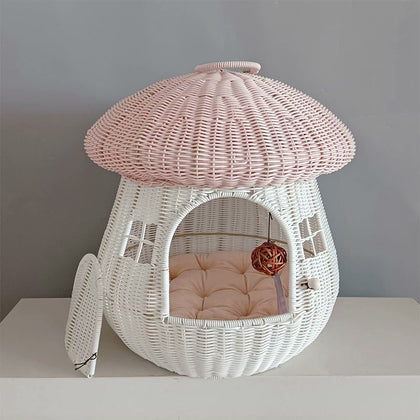  Pink mushroom cat house with a padded cushion inside.