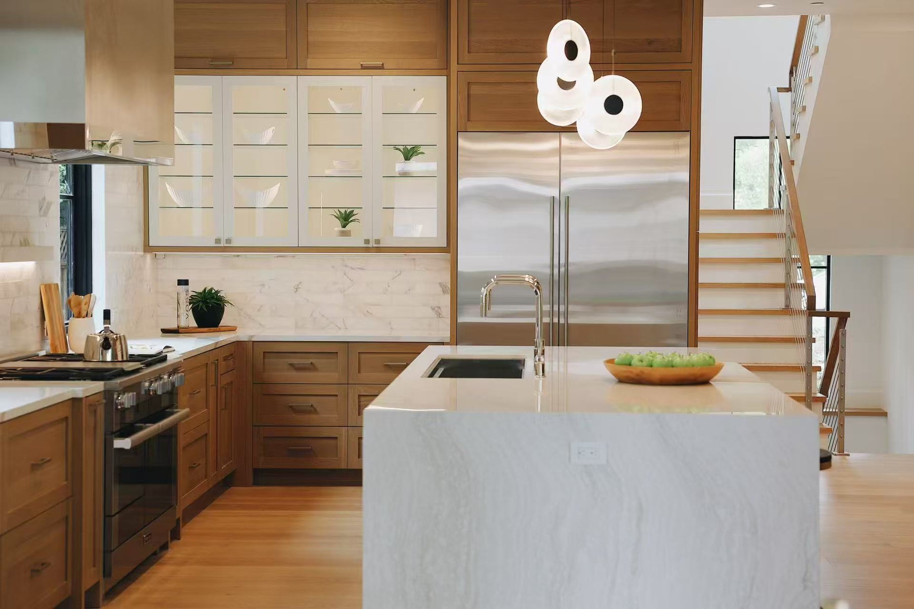Kitchen island, range wall, and timber storage viewed from the seating side