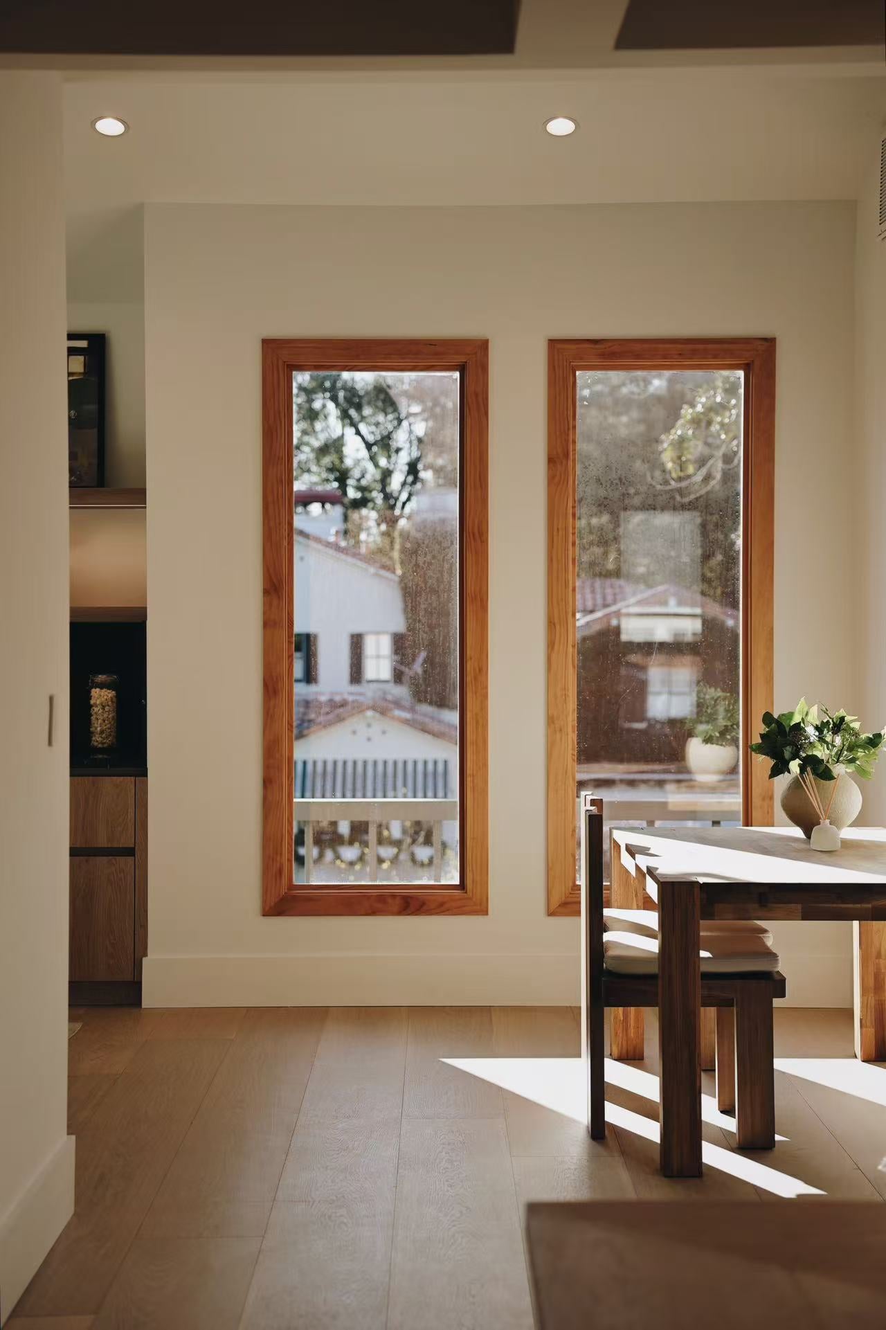 Timber doorway framing a dining area beyond