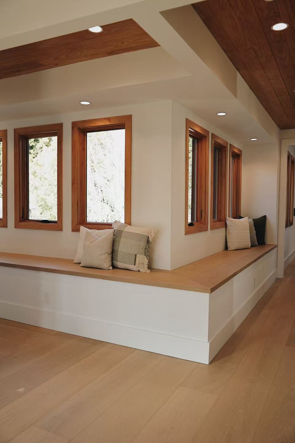 Sunlit interior with timber ceiling detail and sitting area