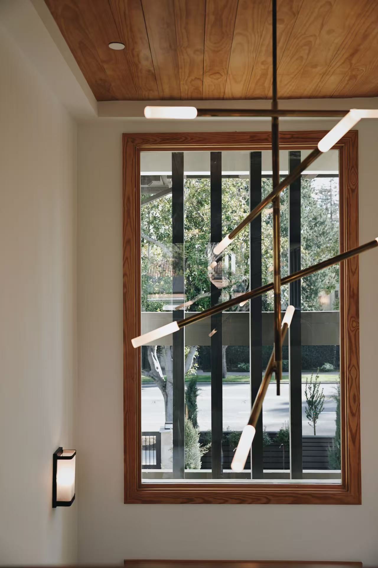 Tall window detail with timber framing and view to exterior stairs