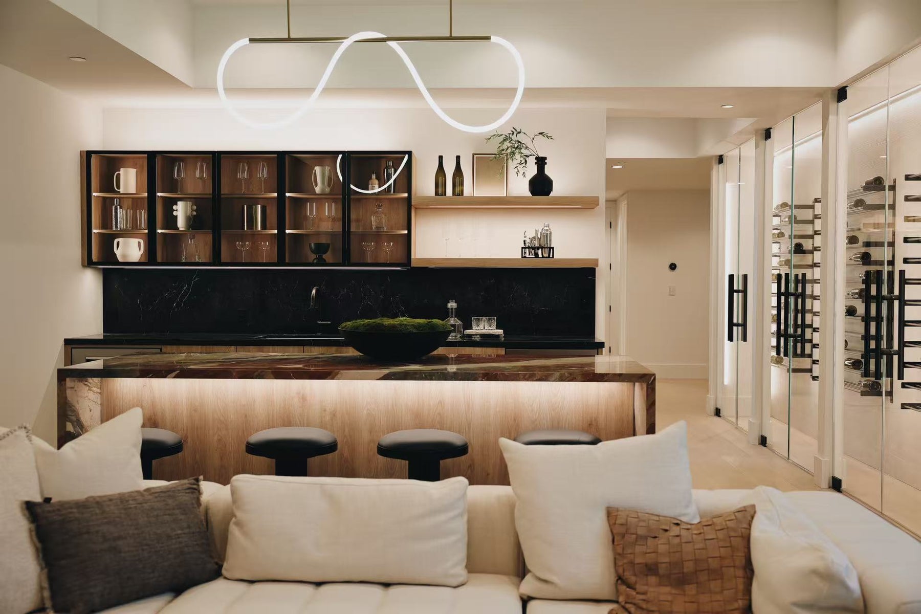 Living room view toward timber kitchen and black stone backsplash