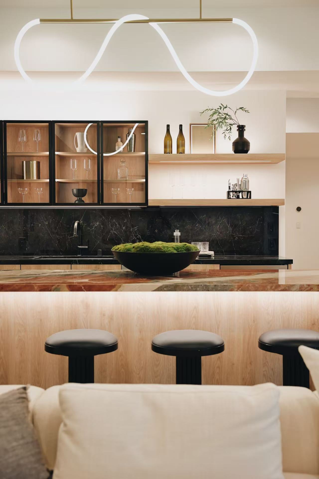 Kitchen and living room with pendant light and timber cabinetry