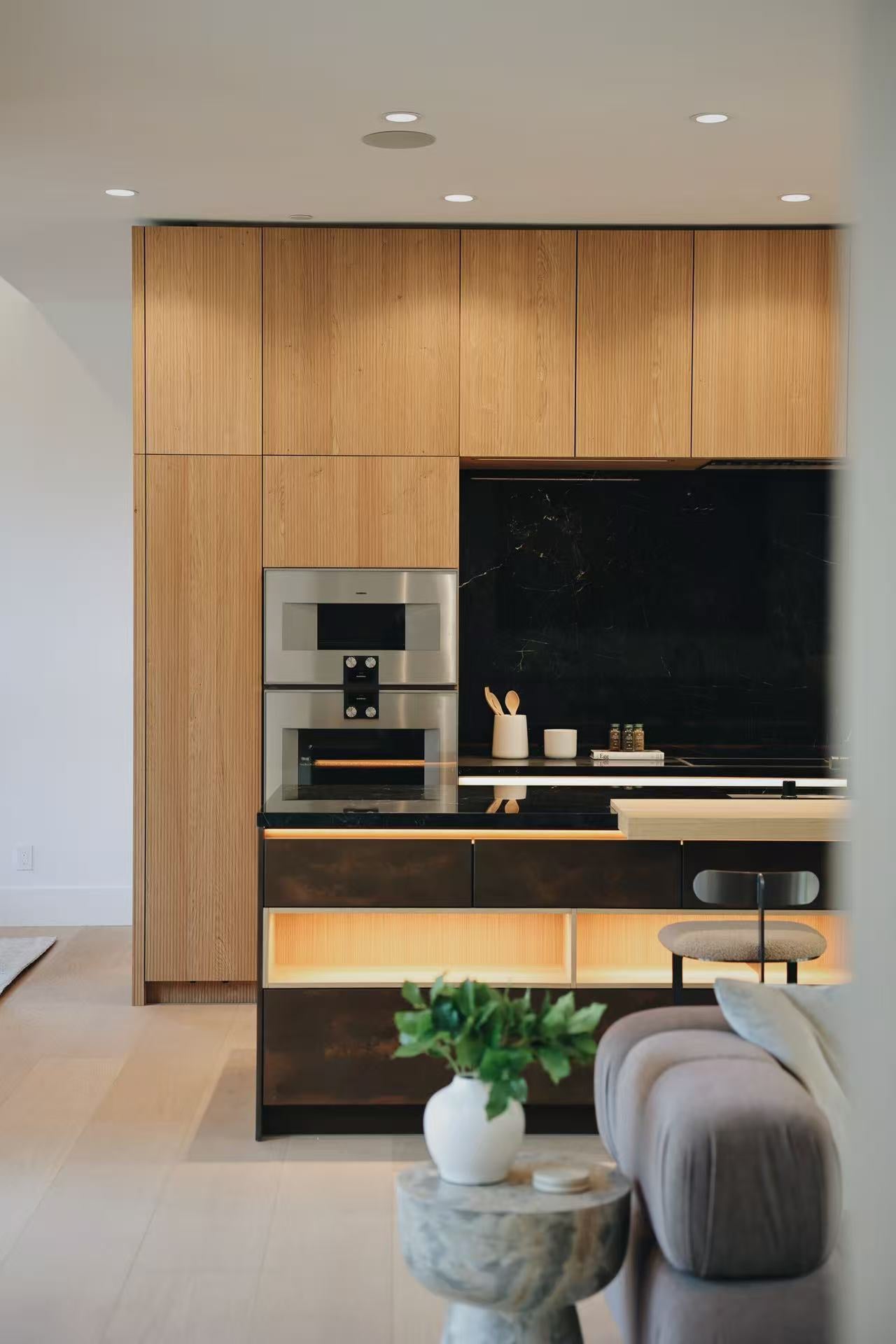 Full-height timber kitchen cabinetry with dark central niche