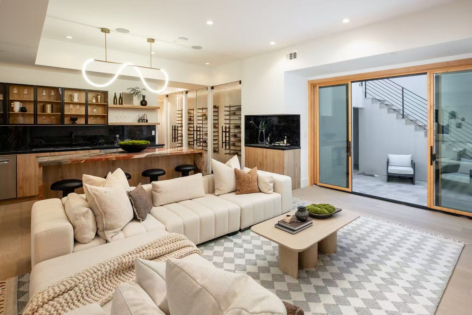 Soft furnished living room with sectional sofa and kitchen beyond