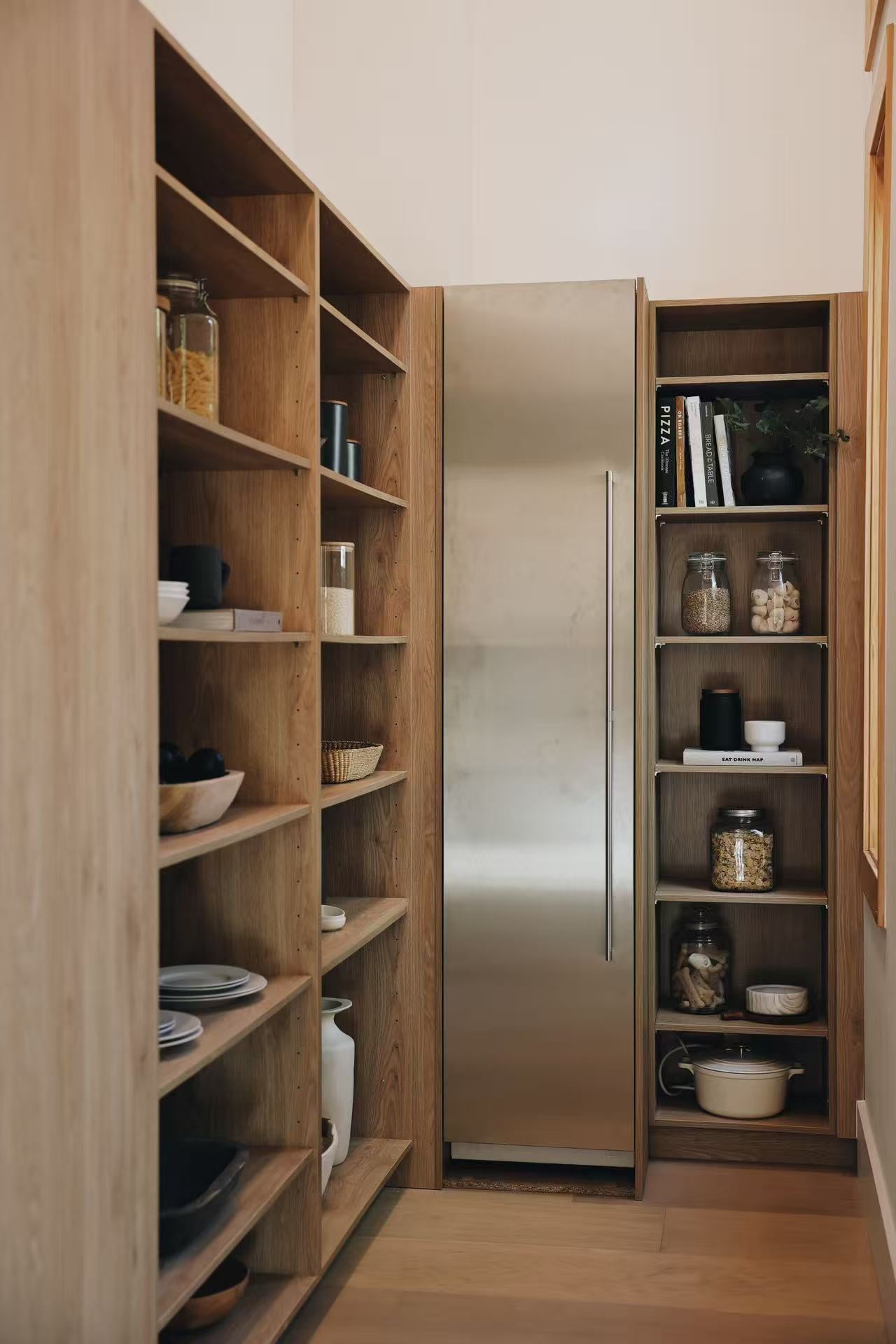Tall open timber shelving with decorative objects